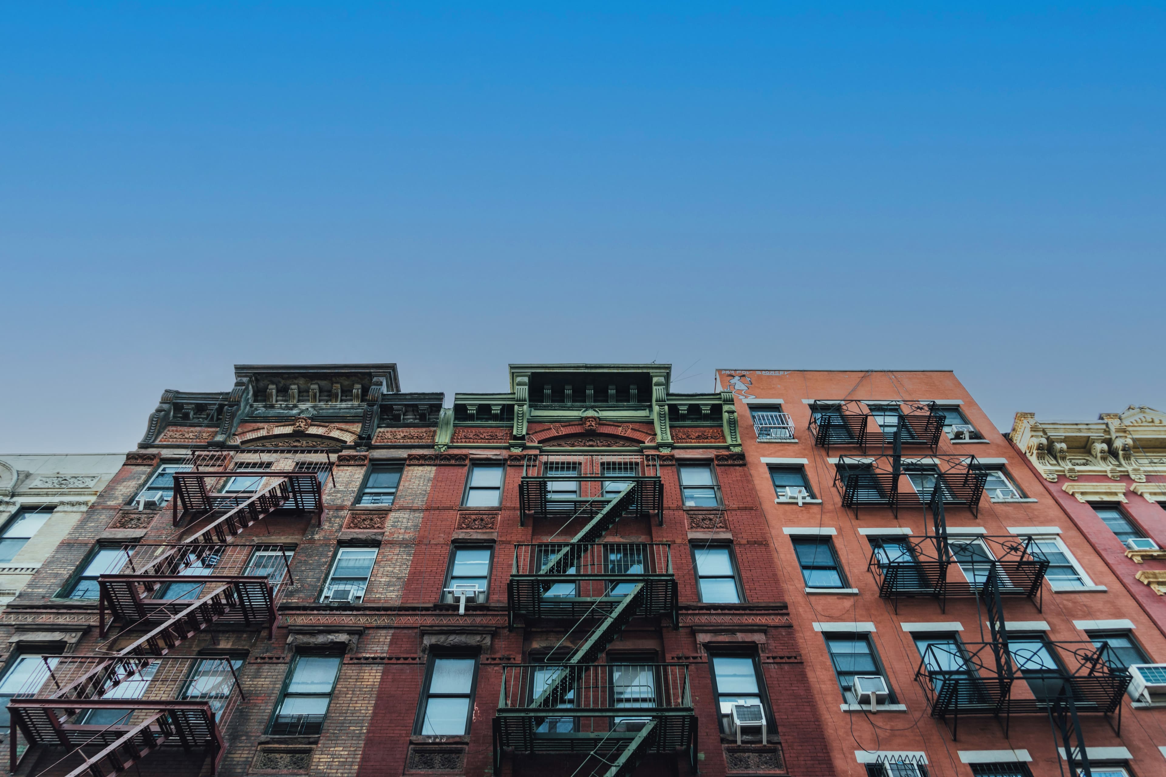 Blue sky above multifamily apartment buildings